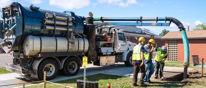 A Man Standing Next To A Truck