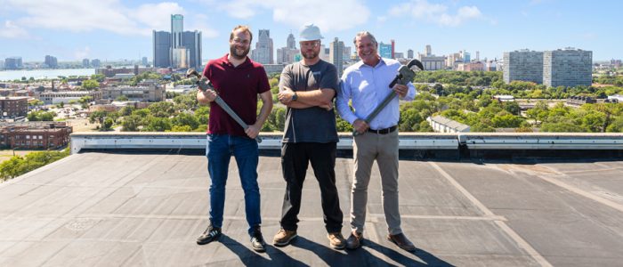 A Group Of People Walking On A Bridge